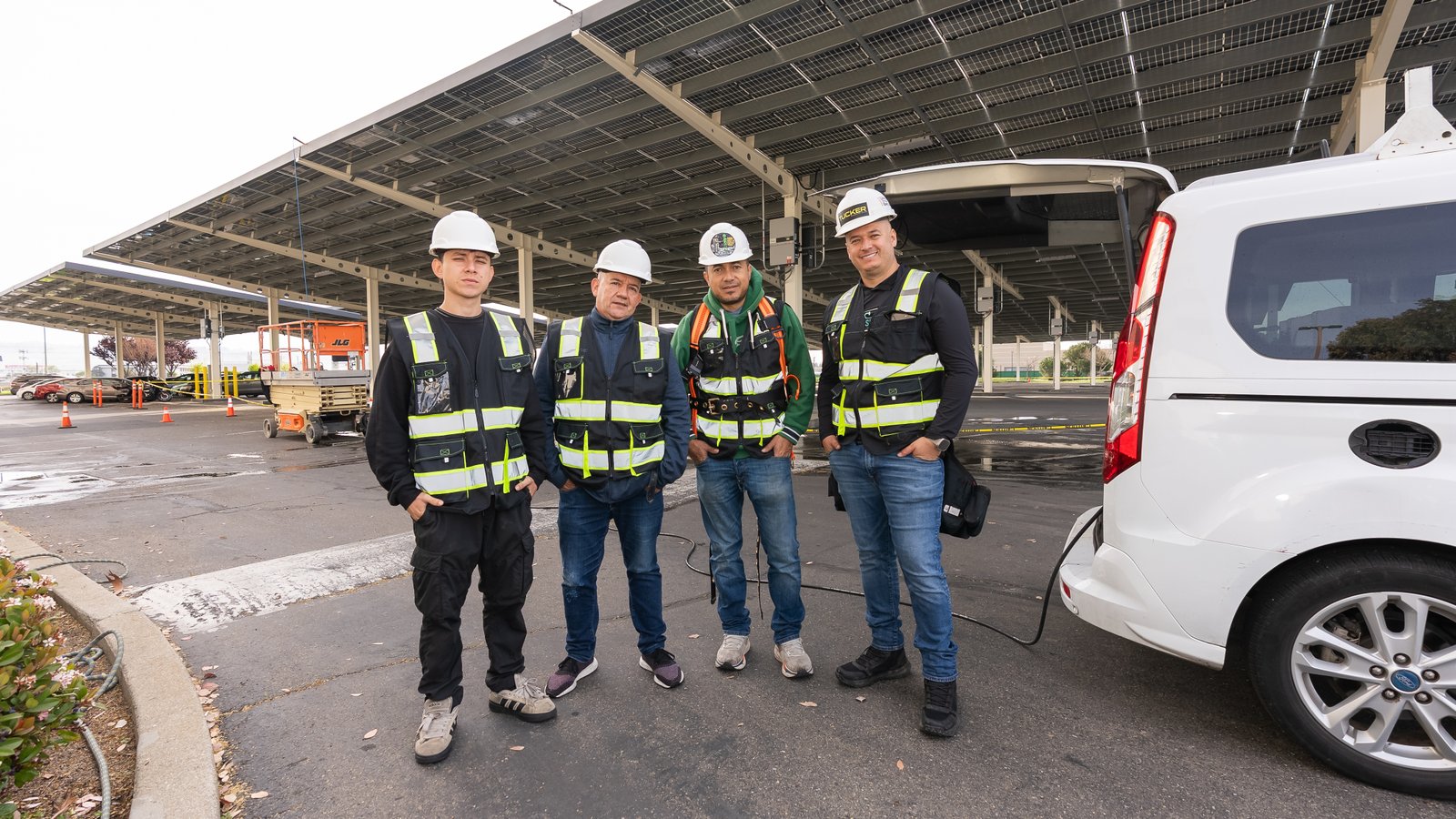 Solar Panel Sparkle cleaning technicians smiling near their work van